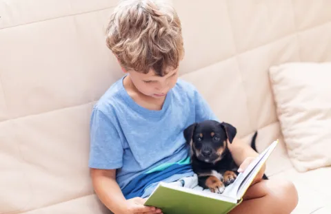 boy reading to dog