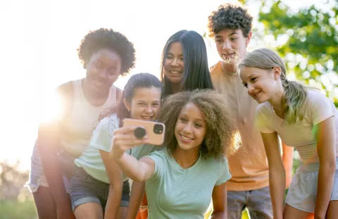 Group of tweens taking selfie