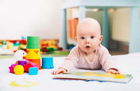 Baby with book and toys